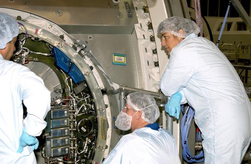 KENNEDY SPACE CENTER, FLA. -  In the Space Station Processing Facility, STS-115 Mission Specialists Joseph Tanner (center) and Heidemarie Stefanyshyn-Piper (right)  look at the inside of the Japanese Experiment Module (JEM) Pressurized Module. Known as Kibo, the JEM consists of six components: two r