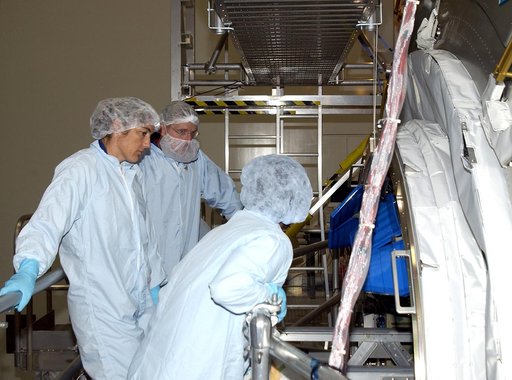 KENNEDY SPACE CENTER, FLA. - In the Space Station Processing Facility, STS-115 Mission Specialists Heidemarie Stefanyshyn-Piper (left) and Joseph Tanner (center) get ready to check out the Japanese Experiment Module (JEM) Pressurized Module. Known as Kibo, the JEM consists of six components: two res