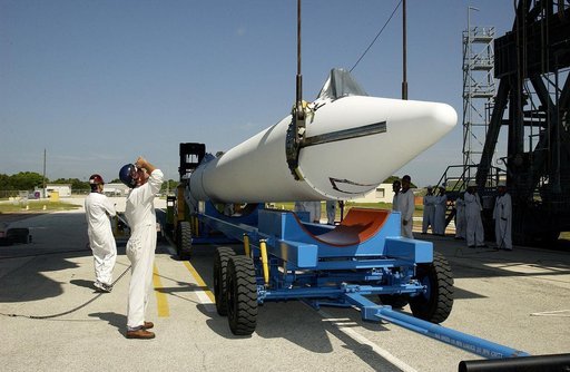 KENNEDY SPACE CENTER, FLA. -   On Launch Complex 17-B, Cape Canaveral Air Force Station, another solid rocket booster (SRB) is being raised from its transporter to lift it to vertical.  It is one of nine  46-inch-diameter, stretched SRBs that are being attached to the Delta II Heavy rocket that will