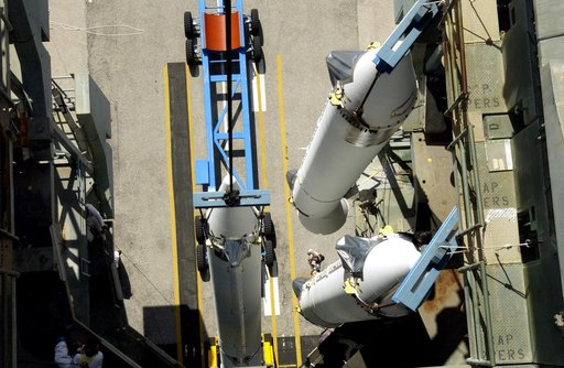 KENNEDY SPACE CENTER, FLA. -   This view from the mobile service tower on Launch Complex 17-B, Cape Canaveral Air Force Station, shows two solid rocket boosters (SRBs) already suspended in the tower while another is being lifted.  They are three of nine  46-inch-diameter, stretched SRBs that are bei