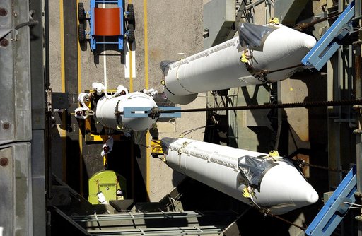 KENNEDY SPACE CENTER, FLA. -   This view from the mobile service tower on Launch Complex 17-B, Cape Canaveral Air Force Station, shows two solid rocket boosters (SRBs) already suspended in the tower while another is being lifted.  They are three of nine  46-inch-diameter, stretched SRBs that are bei