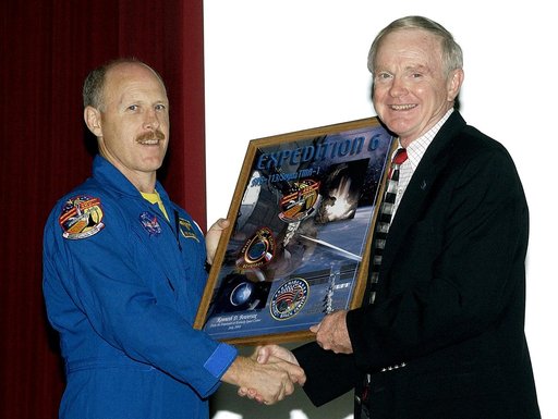 KENNEDY SPACE CENTER, FLA. - Expedition 6 Commander Ken Bowersox (left) accepts from Center Director Roy Bridges Jr. a framed graphic commemorating his stay on the International Space Station.  Bowersox spoke to KSC employees about his mission and residence on the Station from November 25, 2002, to 