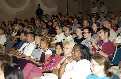 KENNEDY SPACE CENTER, FLA. -  KSC employees fill the Training Auditorium to hear comments from Expedition 6 Commander Ken Bowersox about his mission and residence on the International Space Station from November 25, 2002, to May 3, 2003.