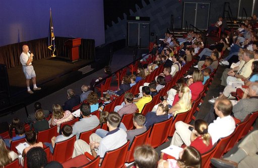 KENNEDY SPACE CENTER, FLA.  -  Former astronaut Story Musgrave talks to employees and their children during a welcome ceremony in the IMAX Theatre, KSC Visitor Complex.  Employees were invited to share their work experience with their children for Take Our Children to Work Day.