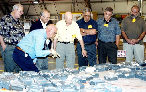 KENNEDY SPACE CENTER, FLA.  -  In the Columbia Debris Hangar, members of the  Stafford-Covey Return to Flight Task Group (SCTG) look at tiles recovered.  Chairing the task group are Richard O. Covey, former Space Shuttle commander, and Thomas P. Stafford (center), Apollo commander.  Chartered by NAS