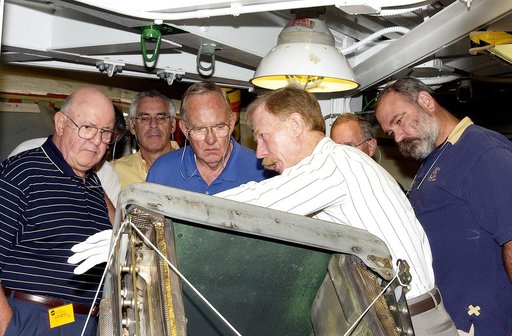 KENNEDY SPACE CENTER, FLA.  - On a tour of the Orbiter Processing Facility, members of the Stafford-Covey Return to Flight Task Group (SCTG) look at one of the Reinforced Carbon-Carbon panels, being shown by Tom Roberts with United Space Alliance, from the orbiter Endeavour.  Chairing the task group
