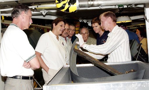 KENNEDY SPACE CENTER, FLA.  - On a tour of the Orbiter Processing Facility, members of the Stafford-Covey Return to Flight Task Group (RTFTG) look at a Reinforced Carbon-Carbon panels with a T-seal held by Tom Roberts, with United Space Alliance.  From left are Richard O. Covey, former Space Shuttle