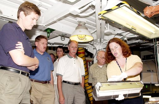 KENNEDY SPACE CENTER, FLA.  -  NASA worker Joy Huff (right) shows a leading edge subsystems (LESS) with tile bonded to it to members of the Stafford-Covey Return to Flight Task Group (SCTG).  From left are Dr. Amy Donahue, David Lengyel, Dr. Kathryn Clark,  Richard Covey, former Space Shuttle comman
