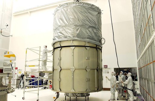 KENNEDY SPACE CENTER, FLA.  -  In Hangar A&E, Cape Canaveral Air Force Station, the upper canister is mated to the middle panels around the Space Infrared Telescope Facility (SIRTF).  The spacecraft will be transported to Launch Complex 17-B for mating with its launch vehicle, the Delta II rocket.  