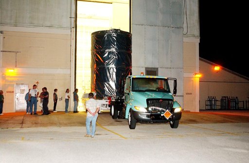 KENNEDY SPACE CENTER, FLA.  -  The Space Infrared Telescope Facility (SIRTF) is rolled out of the hangar at Cape Canaveral Air Force Station during pre-dawn hours.  It is being transported to Launch Pad 17-B where it will be lifted into the mobile service tower and prepared for launch.  SIRTF consis