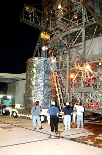 KENNEDY SPACE CENTER, FLA.  -  Before dawn, the Space Infrared Telescope Facility (SIRTF) is attached to an overhead crane that will lift it up the mobile service tower on Launch Pad 17-B, Cape Canaveral Air Force Station.  SIRTF will be attached to the Delta II rocket and encapsulated in its fairin