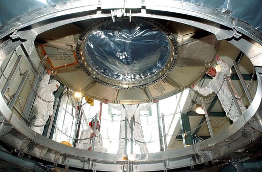 KENNEDY SPACE CENTER, FLA.  -  The Space Infrared Telescope Facility (SIRTF) is lowered into the opening of the mobile service tower on Launch Pad 17-B, Cape Canaveral Air Force Station.  SIRTF will be attached to the Delta II rocket and encapsulated in its fairing before launch.   Consisting of thr
