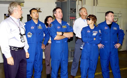 KENNEDY SPACE CENTER, FLA. -  In Hangar AF, Cape Canaveral Air Force Station, the STS-114 crew look at equipment used to disassemble and refurbish solid rocket boosters retrieved after a Shuttle launch.  Starting second from left are Mission Specialist Soichi Noguchi, Mission Specialist Stephen Robi