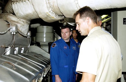KENNEDY SPACE CENTER, FLA. -   Captain Bren Wade of the Liberty Star, one of two SRB Retrieval Ships, talks to STS-114 crew members about the engines.  Seen at left are Pilot James Kelly and Mission Specialist Soichi Noguchi, who is with the Japanese space agency NASDA..   On their mission, the crew