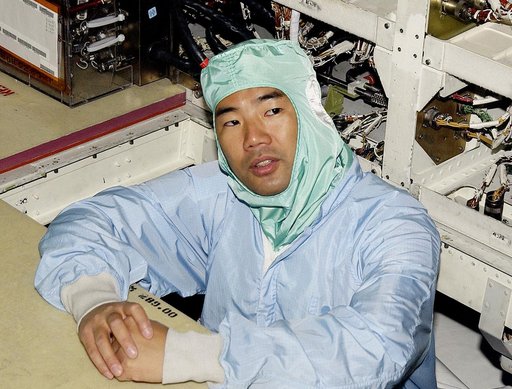 KENNEDY SPACE CENTER, FLA. -   STS-114 Mission Specialist Soichi Noguchi checks the midbody of orbiter Atlantis.  He and other crew members -  Commander Eileen Collins, Pilot James Kelly and Mission Specialist Stephen Robinson - are at KSC for equipment familiarization.  Noguchi is with the Japanese