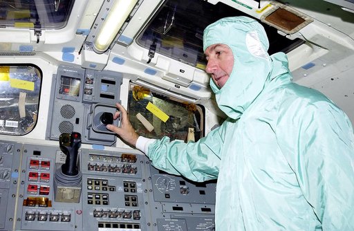 KENNEDY SPACE CENTER, FLA. -   STS-114 Mission Specialist Stephen Robinson checks equipment in the flight deck of orbiter Atlantis.  He and other crew members -  Commander Eileen Collins, Pilot James Kelly and Mission Specialist Soichi Noguchi - are at KSC for equipment familiarization.  Noguchi is 