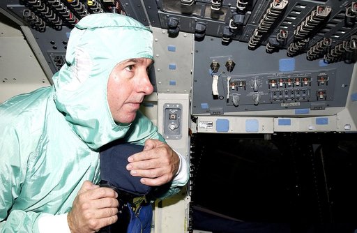 KENNEDY SPACE CENTER, FLA. -   STS-114 Mission Specialist Stephen Robinson looks at equipment in the flight deck of orbiter Atlantis.  He and other crew members -  Commander Eileen Collins, Pilot James Kelly and Mission Specialist Soichi Noguchi - are at KSC for equipment familiarization.  Noguchi i