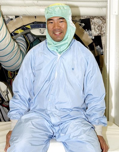 KENNEDY SPACE CENTER, FLA. -  Sitting in the entry hatch to orbiter Atlantis is STS-114 Mission Specialist Soichi Noguchi, who is with the Japanese space agency NASDA. He and other crew members - Commander Eileen Collins, Pilot James Kelly and Mission Specialist Stephen Robinson - are at KSC for equ