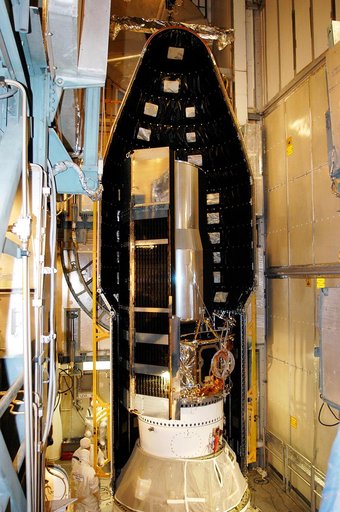 KENNEDY SPACE CENTER, FLA.  - In the mobile service tower on Launch Pad 17-B, Cape Canaveral Air Force Station, the first half of the fairing is moved around the Space Infrared Telescope Facility (SIRTF). SIRTF will obtain images and spectra by detecting the infrared energy, or heat, radiated by obj