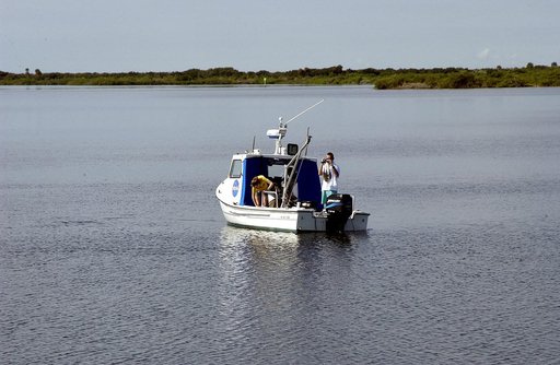 KENNEDY SPACE CENTER, FLA.  -  Researchers are positioned on one of the watercraft being utilized to conduct underwater acoustic research in the Launch Complex 39 turn basin.  Several government agencies, including NASA, NOAA, the Navy, the Coast Guard, and the Florida Fish and Wildlife Commission a