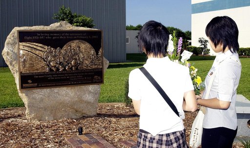 KENNEDY SPACE CENTER, FLA.  -     Japanese girls from Urawa Daiichi Girls High School, Urawa, Japan, carry a floral tribute to the crew of Columbia to place at the STS-107 memorial stone at the Spacehab facility, Cape Canaveral, Fla.   The group was  awarded the trip to Florida when their experiment