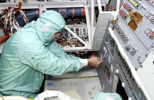 KENNEDY SPACE CENTER, FLA.  -    A technician with United Space Alliance checks wiring in the mid-body of  orbiter Atlantis as part of routine maintenance.