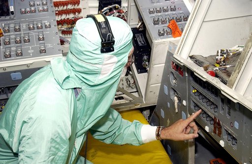 KENNEDY SPACE CENTER, FLA.  -  During power-up of the orbiter Discovery in the Orbiter Processing Facility, a technician moves a switch.  Discovery has been undergoing Orbiter Major Modifications in the past year, ranging from wiring, control panels and black boxes to gaseous and fluid systems tubin