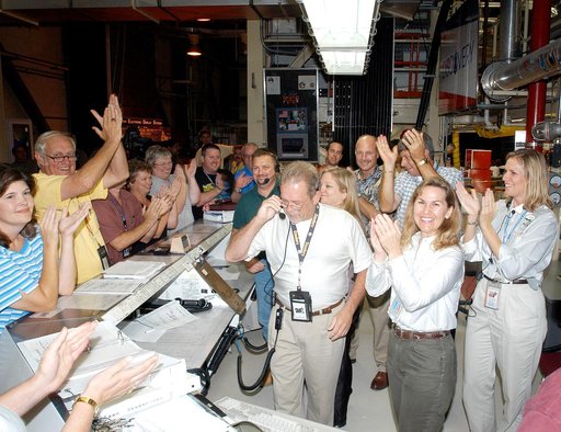 KENNEDY SPACE CENTER, FLA.  -   In the Orbiter Processing Facility, the processing team applaud the successful power-up of the orbiter Discovery.  The vehicle has been undergoing Orbiter Major Modifications in the past year, ranging from wiring, control panels and black boxes to gaseous and fluid sy