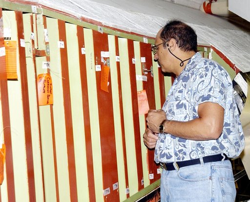 KENNEDY SPACE CENTER, FLA. - In the Orbiter Processing Facility (OPF), a United Space Alliance technician examines the attachment points for the spars on the exterior of a wing of Space Shuttle Atlantis. Reinforced Carbon Carbon (RCC) panels are mechanically attached to the wing with a series of flo
