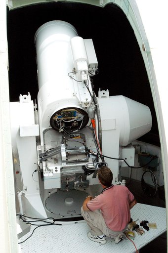 KENNEDY SPACE CENTER, FLA. -   Workers calibrate a tracking telescope, part of the Distant Object Attitude Measurement System (DOAMS),  located in Cocoa Beach, Fla.  The telescope provides optical support for launches from KSC and Cape Canaveral.