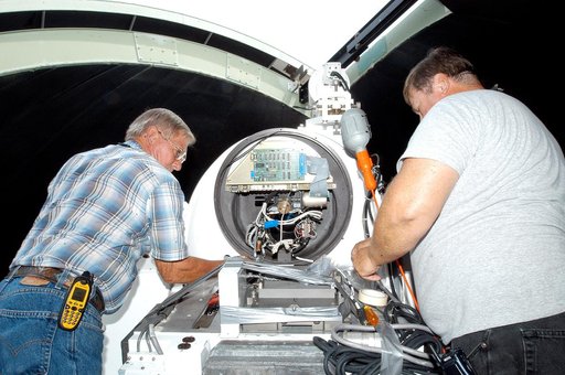 KENNEDY SPACE CENTER, FLA. - A worker calibrates a tracking telescope, part of the Distant Object Attitude Measurement System (DOAMS),  located in Cocoa Beach, Fla.  The telescope provides optical support for launches from KSC and Cape Canaveral.