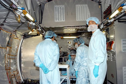 KENNEDY SPACE CENTER, FLA. -   Astronaut Soichi Noguchi (right), with the National Space Development Agency of Japan (NASDA), is inside the Japanese Experiment Module (JEM), undergoing a Multi-Element Integrated Test (MEIT)  in the Space Station Processing Facility.  Noguchi is assigned to mission S