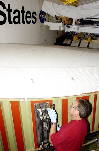 KENNEDY SPACE CENTER, FLA. -  In the Orbiter Processing Facility, Mike Hyatt, with United Space Alliance, installs a spar on the wing of the orbiter Atlantis.  Reinforced Carbon Carbon (RCC) panels are mechanically attached to the wing with a series of floating joints - spars - to reduce loading on 