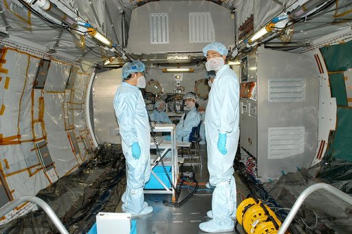 KENNEDY SPACE CENTER, FLA. -  In the Space Station Processing Facility, astronaut Soichi Noguchi (right), with the National Space Development Agency of Japan (NASDA), stands inside the Japanese Experiment Module (JEM) that is undergoing a Multi-Element Integrated Test (MEIT) with the U.S. Node 2.  T