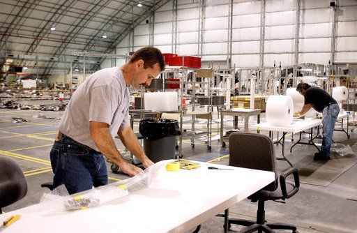 KENNEDY SPACE CENTER, FLA. -In the Columbia Debris Hangar, Don Eitel (left) wraps pieces of Columbia debris for storage.  About 83,000 pieces of debris were shipped to KSC during search and recovery efforts in East Texas. That represents about 38 percent of the dry weight of Columbia, equaling almos