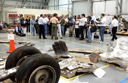 KENNEDY SPACE CENTER, FLA. - The media listen to Scott Thurston, NASA vehicle flow manager, talk about efforts to pack the debris stored in the Columbia Debris Hangar.  More than 83,000  pieces of debris were shipped to KSC during search and recovery efforts in East Texas. That represents about 38 p