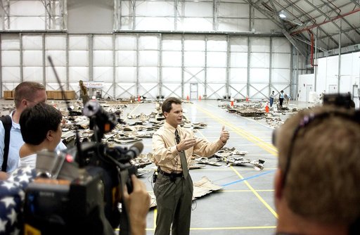 KENNEDY SPACE CENTER, FLA. - In the Columbia Debris Hangar, Scott Thurston, NASA vehicle flow manager, addresses the media about efforts to pack the debris stored in the Columbia Debris Hangar.  More than 83,000  pieces of debris were shipped to KSC during search and recovery efforts in East Texas. 