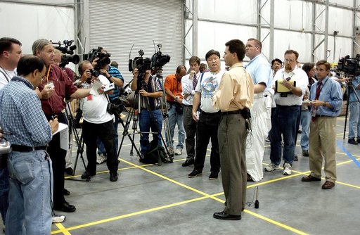 KENNEDY SPACE CENTER, FLA. - In the Columbia Debris Hangar, Scott Thurston, NASA vehicle flow manager, addresses the media about efforts to pack the debris stored in the Columbia Debris Hangar.  More than 83,000  pieces of debris were shipped to KSC during search and recovery efforts in East Texas. 