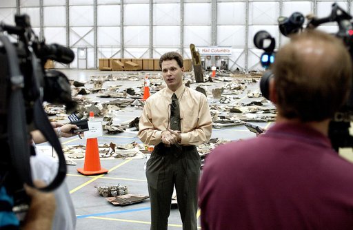 KENNEDY SPACE CENTER, FLA. - In the Columbia Debris Hangar, Scott Thurston, NASA vehicle flow manager, addresses the media about efforts to pack the debris stored in the Columbia Debris Hangar.  More than 83,000  pieces of debris were shipped to KSC during search and recovery efforts in East Texas. 