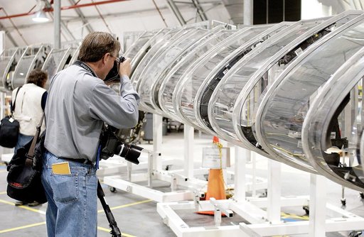 KENNEDY SPACE CENTER, FLA. - During a media tour of the Columbia Debris Hangar, a photographer gets a close-up of the mockup of the leading edge of Columbia’s left wing.  About 83,000 pieces of debris were shipped to KSC from search and recovery efforts in East Texas.  About 83,000 pieces of debris 