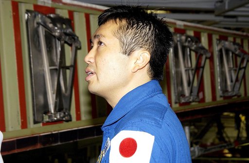 KENNEDY SPACE CENTER, FLA. - Japanese astronaut Koichi Wakata looks at the spars installed on the wing of the orbiter Atlantis.  Reinforced Carbon Carbon (RCC) panels are mechanically attached to the wing via the spars - a series of floating joints - to reduce loading on the panels caused by wing de