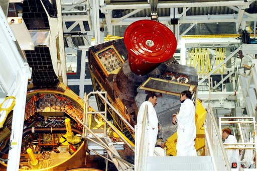 KENNEDY SPACE CENTER, FLA. -   Technicians in the Orbiter Processing Facility oversee removal of one of two orbital maneuvering system (OMS) pods from Endeavour.  The OMS pods are attached to the upper aft fuselage left and right sides.  Fabricated primarily of graphite epoxy composite and aluminum,