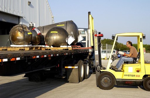 KENNEDY SPACE CENTER, FLA. -   Some of the Columbia debris is loaded onto a flatbed truck outside the Columbia Debris Hangar.  The debris is being transferred to the Vehicle Assembly Building for permanent storage.  More than 83,000  pieces of debris were shipped to KSC during search and recovery ef