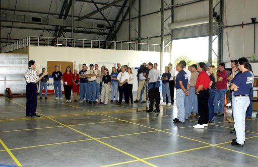 KENNEDY SPACE CENTER, FLA. -  Scott Thurston, NASA vehicle flow manager, speaks to members of the Columbia Reconstruction Team during transfer of debris from the Columbia Debris Hangar to its permanent storage site in the Vehicle Assembly Building.  More than 83,000 pieces of debris were shipped to 
