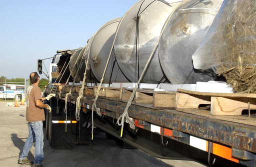 KENNEDY SPACE CENTER, FLA. -  At the Columbia Debris Hangar, some of the debris of Space Shuttle Columbia is secured onto a flatbed truck for transfer to the Vehicle Assembly Building for permanent storage.  More than 83,000  pieces of debris were shipped to KSC during search and recovery efforts in
