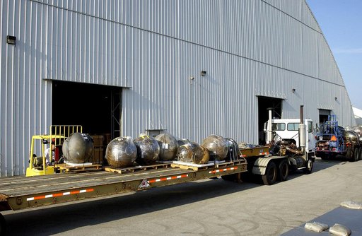 KENNEDY SPACE CENTER, FLA. -  At the Columbia Debris Hangar, some of the debris of Space Shuttle Columbia is moved onto a flatbed truck for transfer to the Vehicle Assembly Building for permanent storage.  More than 83,000 pieces of debris were shipped to KSC during search and recovery efforts in Ea