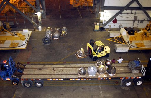 KENNEDY SPACE CENTER, FLA. -  Pieces of debris of Space Shuttle Columbia are offloaded from a flatbed truck in the transfer aisle of the Vehicle Assembly Building (VAB).  The debris is being moved from the Columbia Debris Hangar to the VAB for permanent storage.  More than 83,000 pieces of debris we