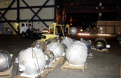 KENNEDY SPACE CENTER, FLA. -  Pieces of debris of Space Shuttle Columbia are offloaded from a flatbed truck in the transfer aisle of the Vehicle Assembly Building (VAB).  The debris is being moved from the Columbia Debris Hangar to the VAB for permanent storage.  More than 83,000 pieces of debris we