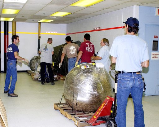 KENNEDY SPACE CENTER, FLA. -  Workers move some of the Columbia debris to its storage site in the Vehicle Assembly Building (VAB). The debris is being transferred from the Columbia Debris Hangar to the VAB for permanent storage.  More than 83,000 pieces of debris were shipped to KSC during search an