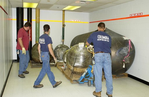 KENNEDY SPACE CENTER, FLA.  -   Workers place some of the Columbia debris moved from the Columbia Debris Hangar in its permanent storage site in the Vehicle Assembly Building.  More than 83,000  pieces of debris were shipped to KSC during search and recovery efforts in East Texas. That represents ab